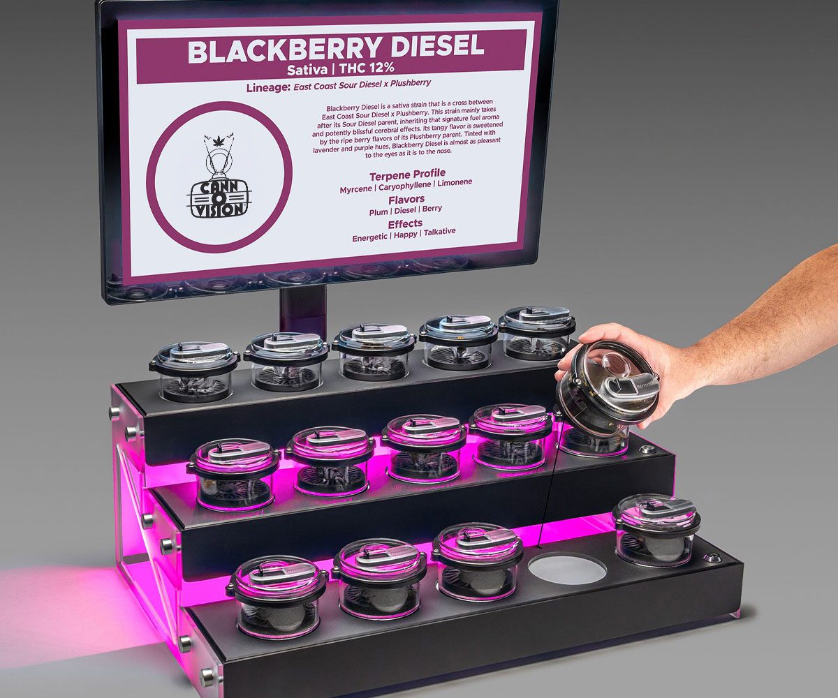 Cann-O-Vision™ lift-and-learn cannabis display showing strain information on screen as a customer examines a flower sample