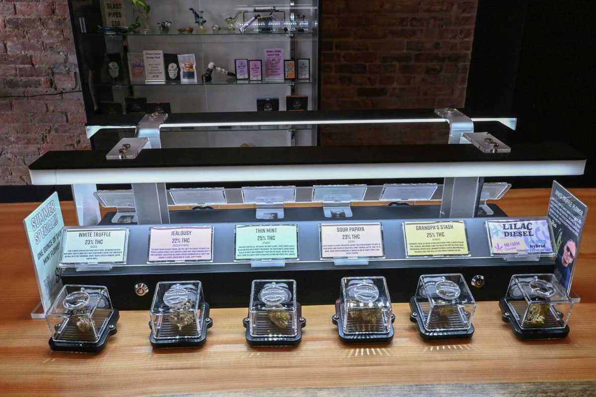 Cannabis display promoting featured summer strains with illuminated countertop merchandising.