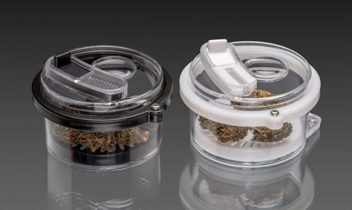 Black and white Canna-Pod® cannabis sample pods with magnified viewing lenses and flower samples displayed inside.